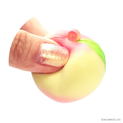Yellow pink iBloom capsule peach squishy being squeezed showing slow rising squish texture